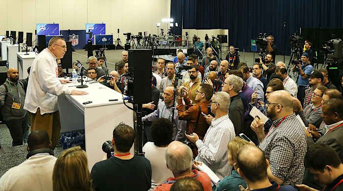 Browns GM John Dorsey faces a throng of reporters at the combine.
